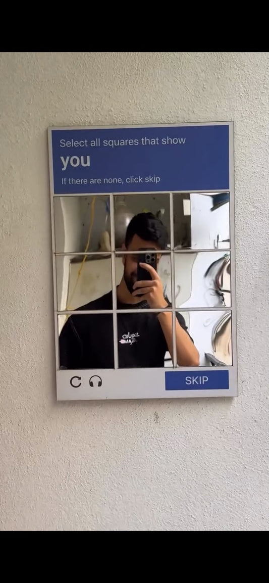 CAPTCHA style wall mirror mounted on wall showing reflection of a person, funny novelty mirror